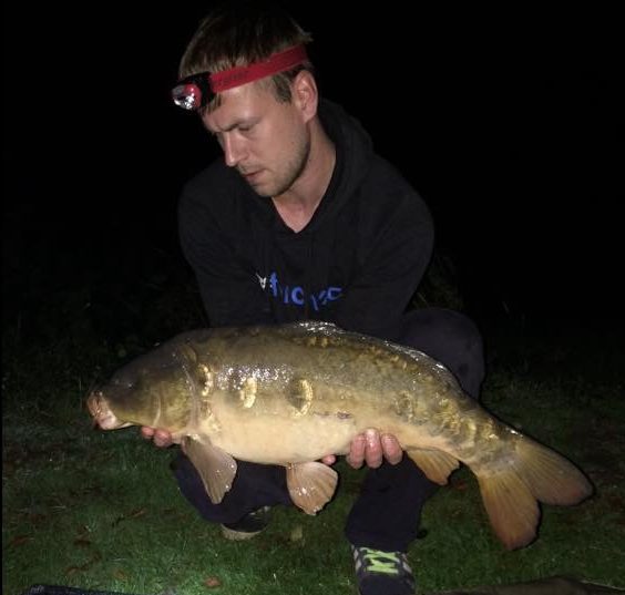 A photo of Andrew Pearce with a carp he landed from the top lake