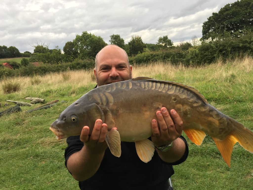 A photo of Ian Barber with a monster carp.