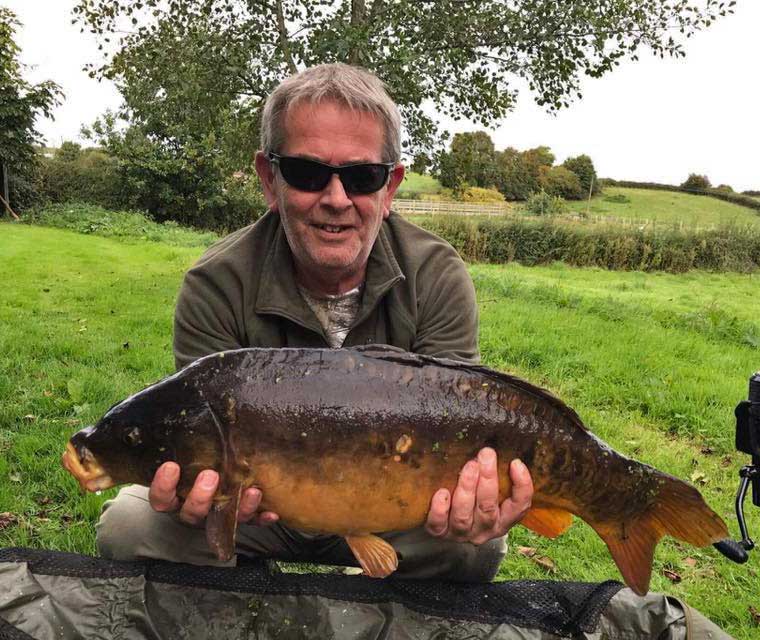 A photo of a lovely dark fish caught by Ian from Elton top lake.